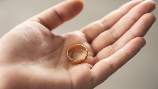 person holding a wedding ring