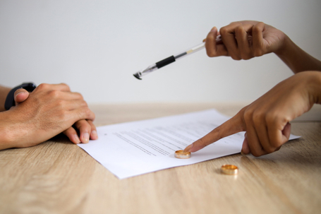 couple signing divorce papers